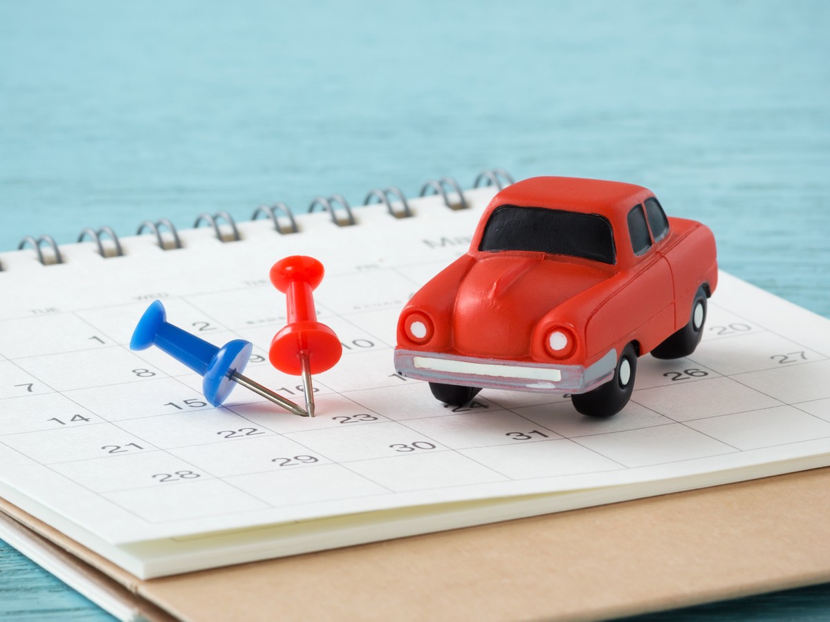 Toy Car And Pins On Calendar