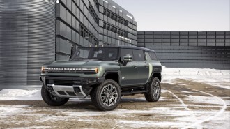 The 2023 GMC Hummer EV pickup and SUV facing each other
