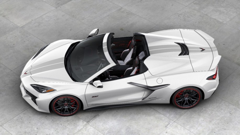 The 2023 Corvette Z06 70th anniversary edition convertible sits parked on Concrete. The car is white, with gray stripes. We see it from an overhead angle.