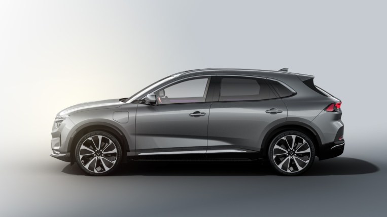 The 2023 VinFast VF8 sits parked against a white backdrop. We see the SUV in profile, facing to our left. It is gunmetal gray.