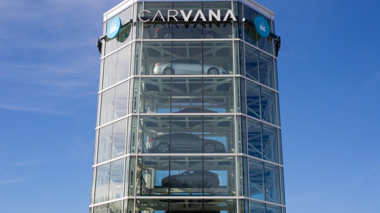 A Carvana "car vending machine." It is a glass-covered, 8-sided towere filled with cars, which can lower to the ground below on a moving platform.