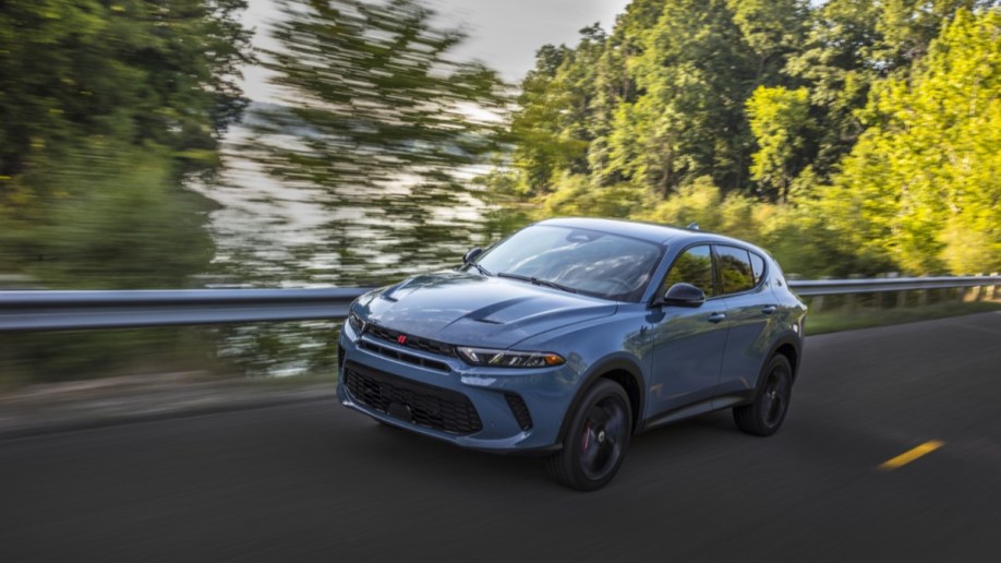 The 2023 Dodge Hornet seen from a front quarter angle. The SUV is a chalky light blue. We see it facing slightly to our left.