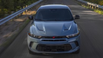 The 2023 Dodge Hornet seen from head-on. The SUV is a chalky shade of blue, with vents and deep character lines in its hood.
