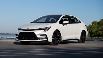 2023 Toyota Corolla in white near a lake.