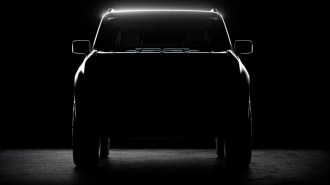 A teaser shot shows a head-on view of the first Scout EV prototype
