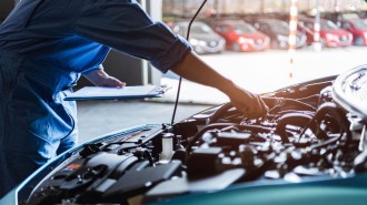 A mechanic works on an engine