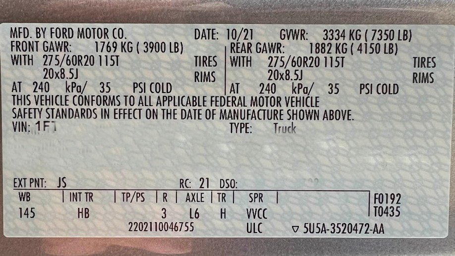 The sticker from a Ford F-150 door jamb showing towing specifications