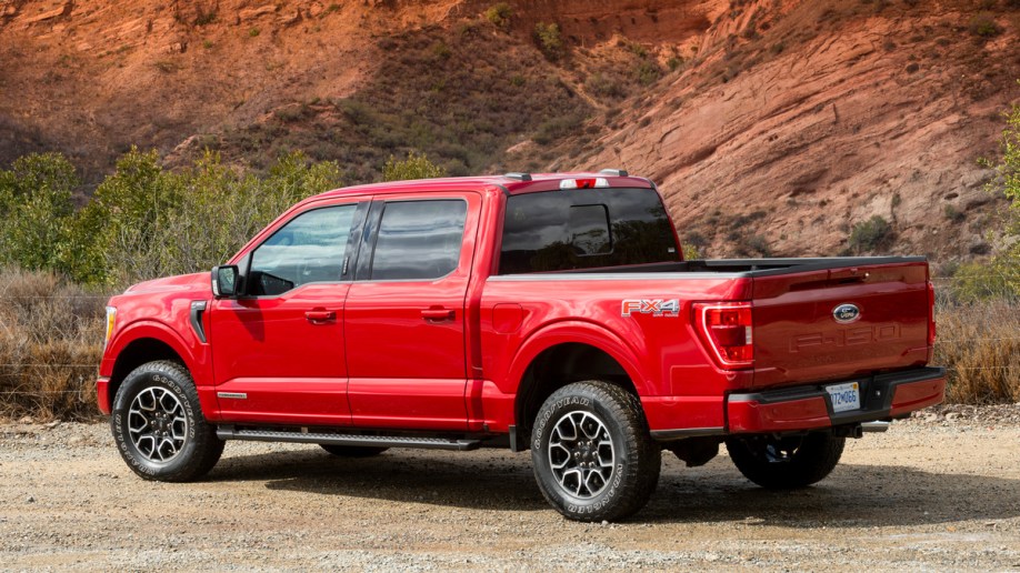 Red 2021 Ford F-150 Hybrid near hill