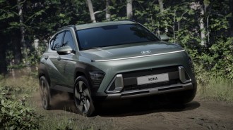 2024 Hyundai Kona Electric driving on a dirt road.