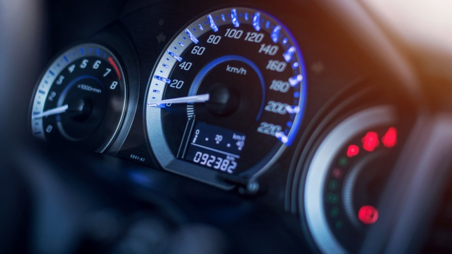 A closeup of a car's dashboard showing a digital odometer 