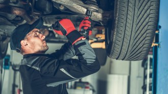 A technician working on a shocks and struts repair