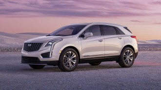 2023 Cadillac XT5 Premium Luxury at sunset with sandy hills in the background.
