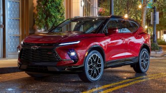Red 2023 Chevrolet Blazer RS parked on a street at night.