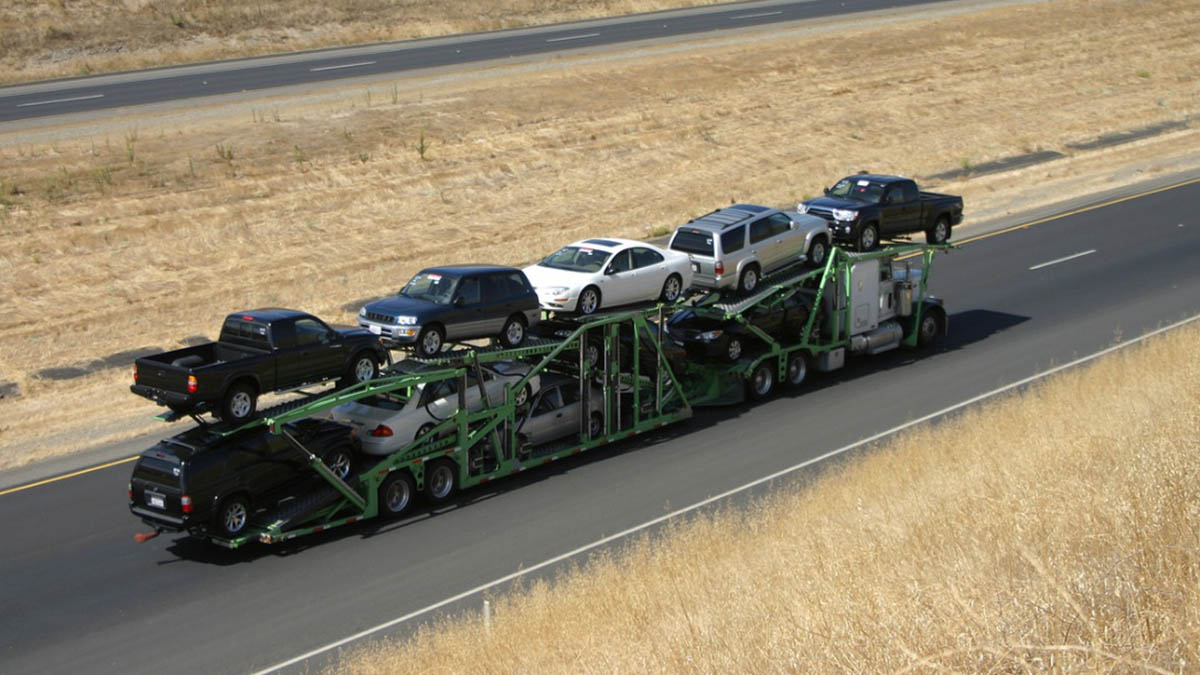 Tractor-trailer car carrier transporting automobiles on a highway