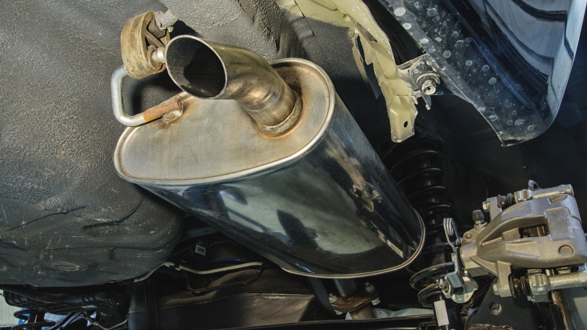 A muffler mounted to a car's undercarriage