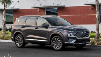 Grey 2023 Hyundai Santa Fe parked near a building.