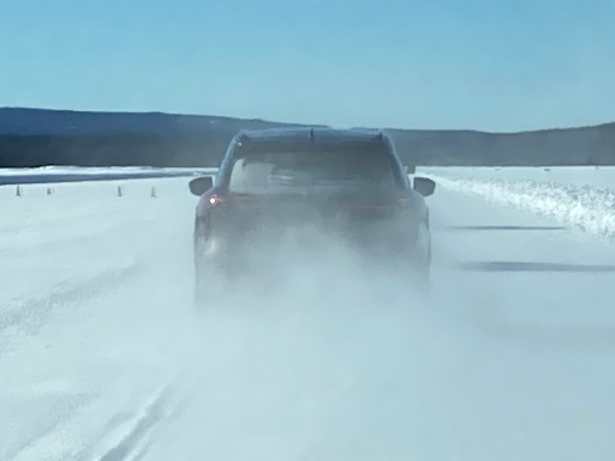 2023 Infiniti QX60 rear view on snow course.