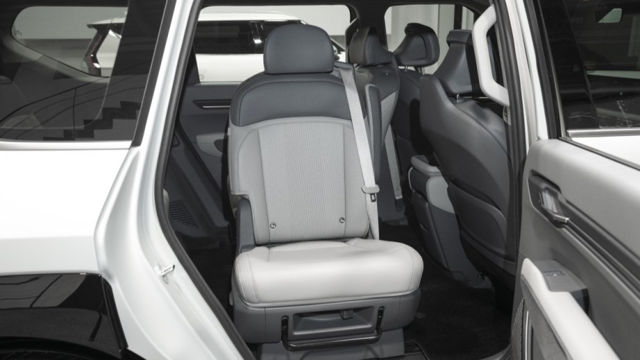 The second-row seats of the 2024 Kia EV9, swiveled to face out the open doors