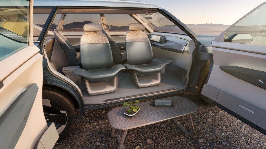 The Kia EV5 Concept with its coach-style doors open and seats facing out