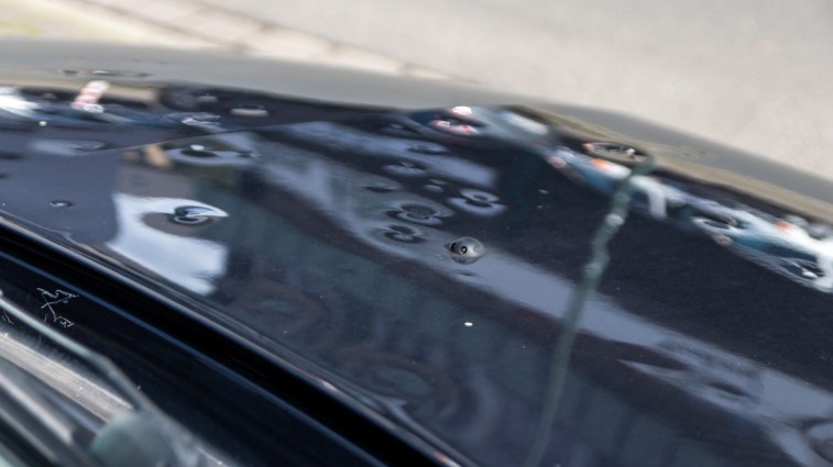 Dents from hail damage on a car hood