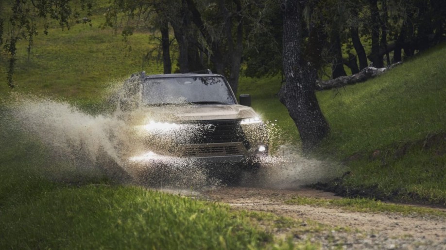 The 2024 Lexus GX splashes through a puddle