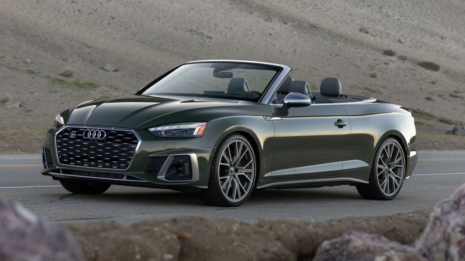 2023 Audi S5 cabrio in green near dunes at sunset.