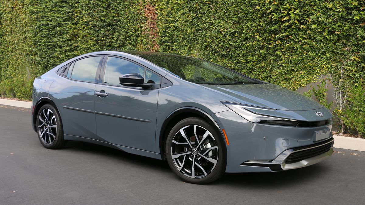 2023 Toyota Prius Prime in grey near an ivy wall.