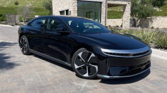 2023 Lucid Air Pure in black near stone building.