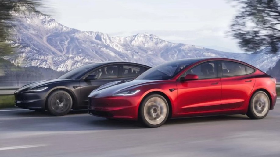 A pair of restyled 2024 Tesla Model 3 sedans seen from a front quarter angle 