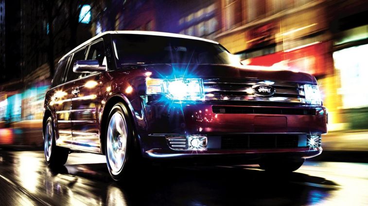 2010 Ford Flex driving at night.