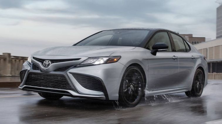 2024 Toyota Camry driving on the road.