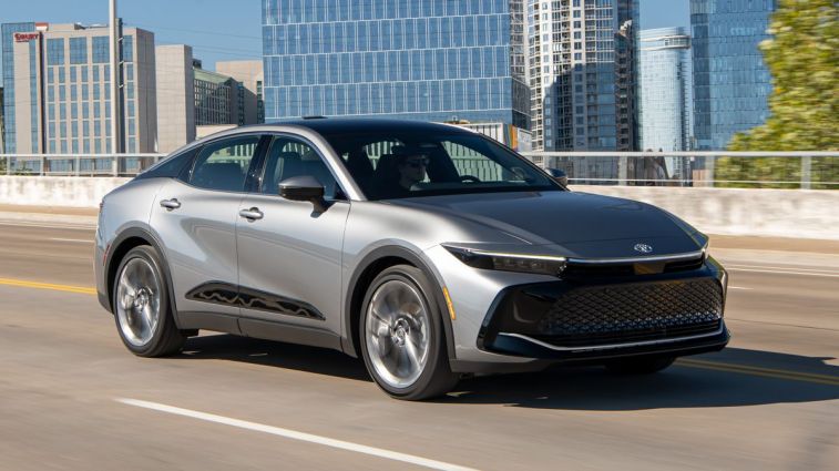 2024 Toyota Crown Limited in Heavy Metal driving down a highway.