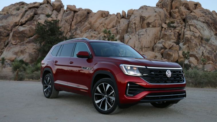2024 Volkswagen Atlas SEL in red with rock formations in the background.