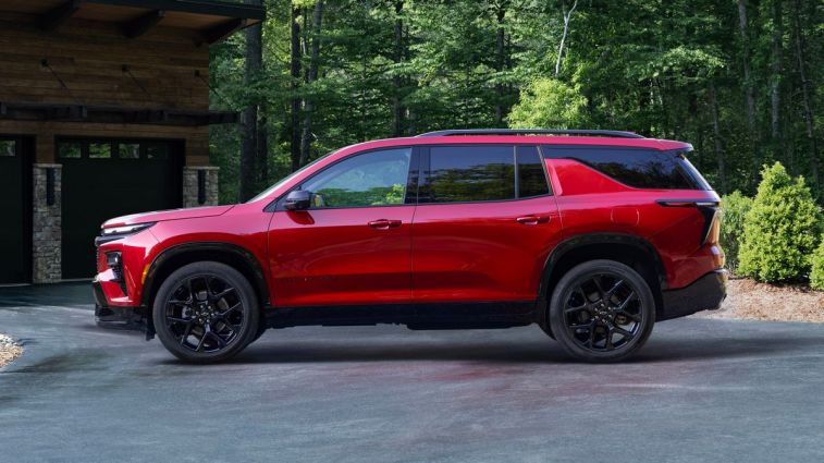 2024 Chevrolet Traverse RS in Radiant Red Tintcoat parked in a driveway.