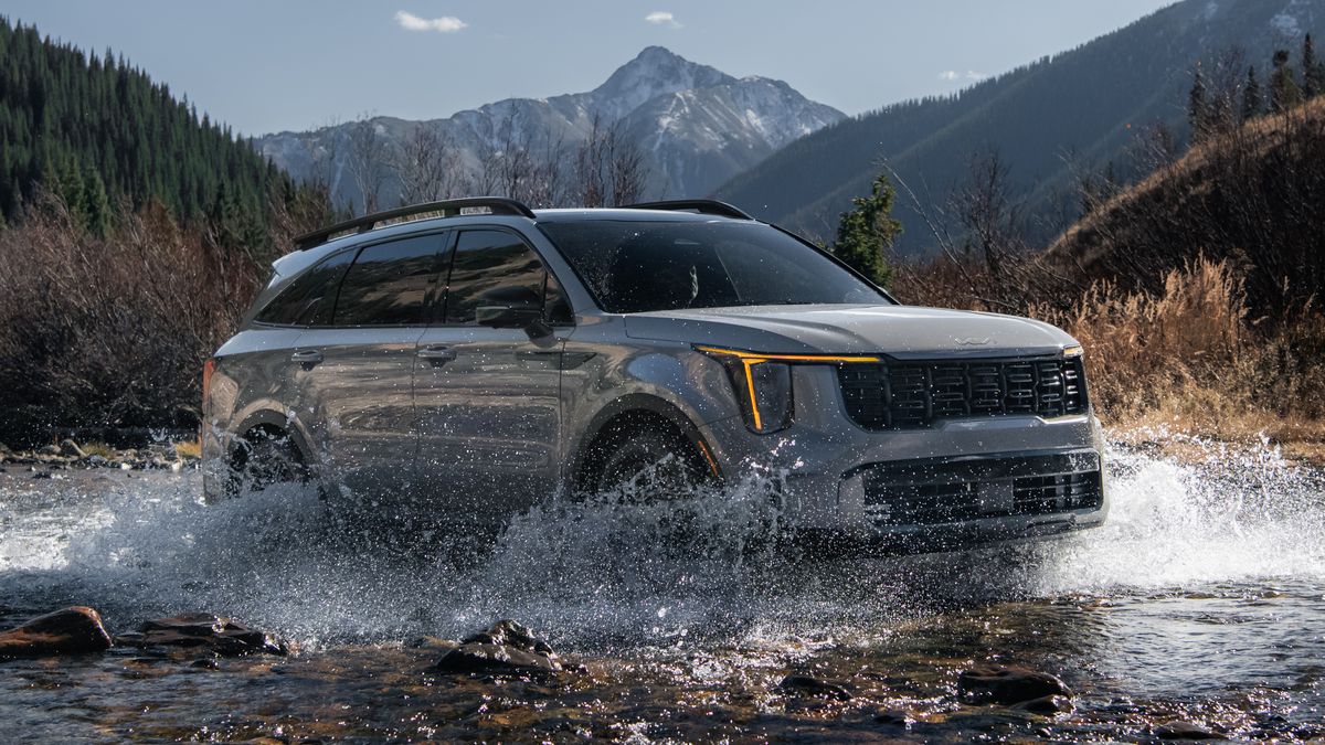 2024 Kia Sorento X-Pro driving through a stream.