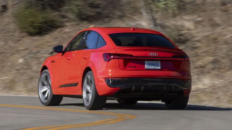 Rear view of the 2024 Audi SQ8 Sportback e-tron in red driving