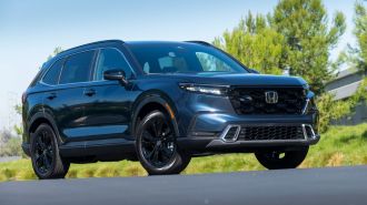 2024 Honda CR-V Hybrid with trees in the background.