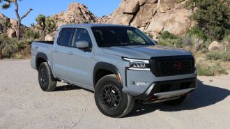 2024 Nissan Frontier Pro-4X in grey with rock formations in the background.