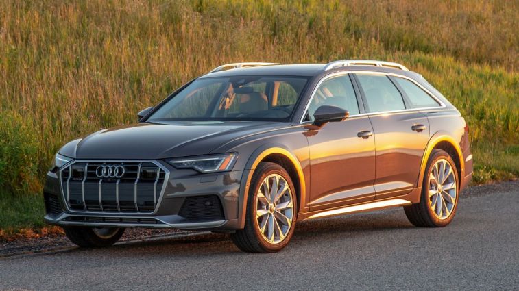 2024 Audi A6 Allroad with a grassy hill in the background.