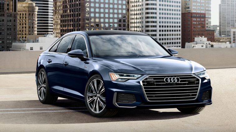 2024 Audi A6 parked on a rooftop with buildings in the background.