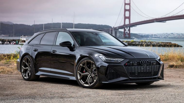 2024 Audi RS6 Avant Performance in black with a bridge in the background.
