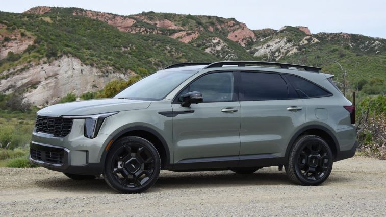 2024 Kia Sorento X-Line in Jungle Green with hills in the background.