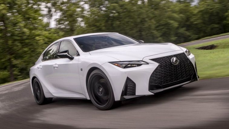 2024 Lexus IS 350 F-Sport in white driving around a corner.