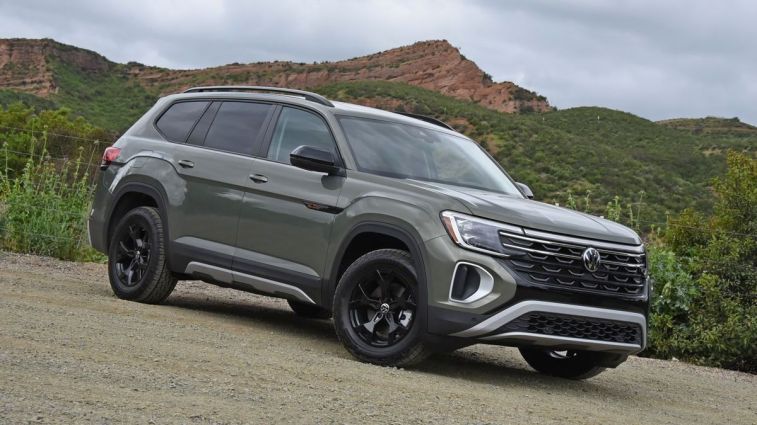 2024 Volkswagen Atlas Peak Edition in Avocado Green with red hills in the background.