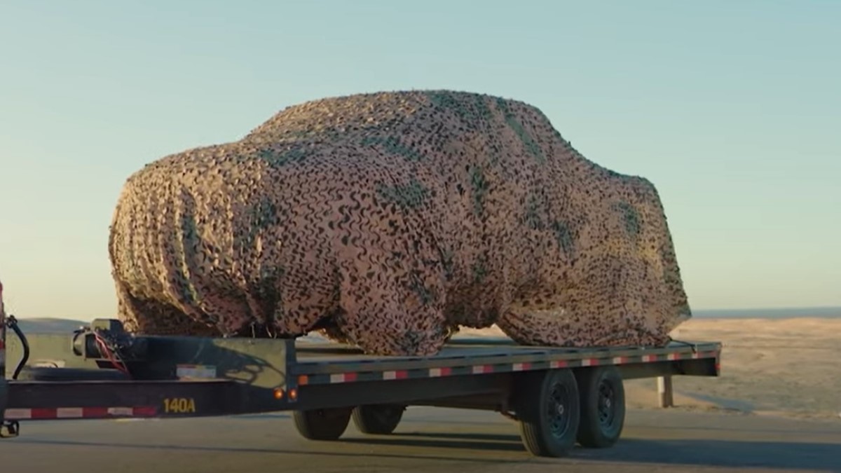 A teaser photo showing the 2025 Ram RHO under a camouflage cover