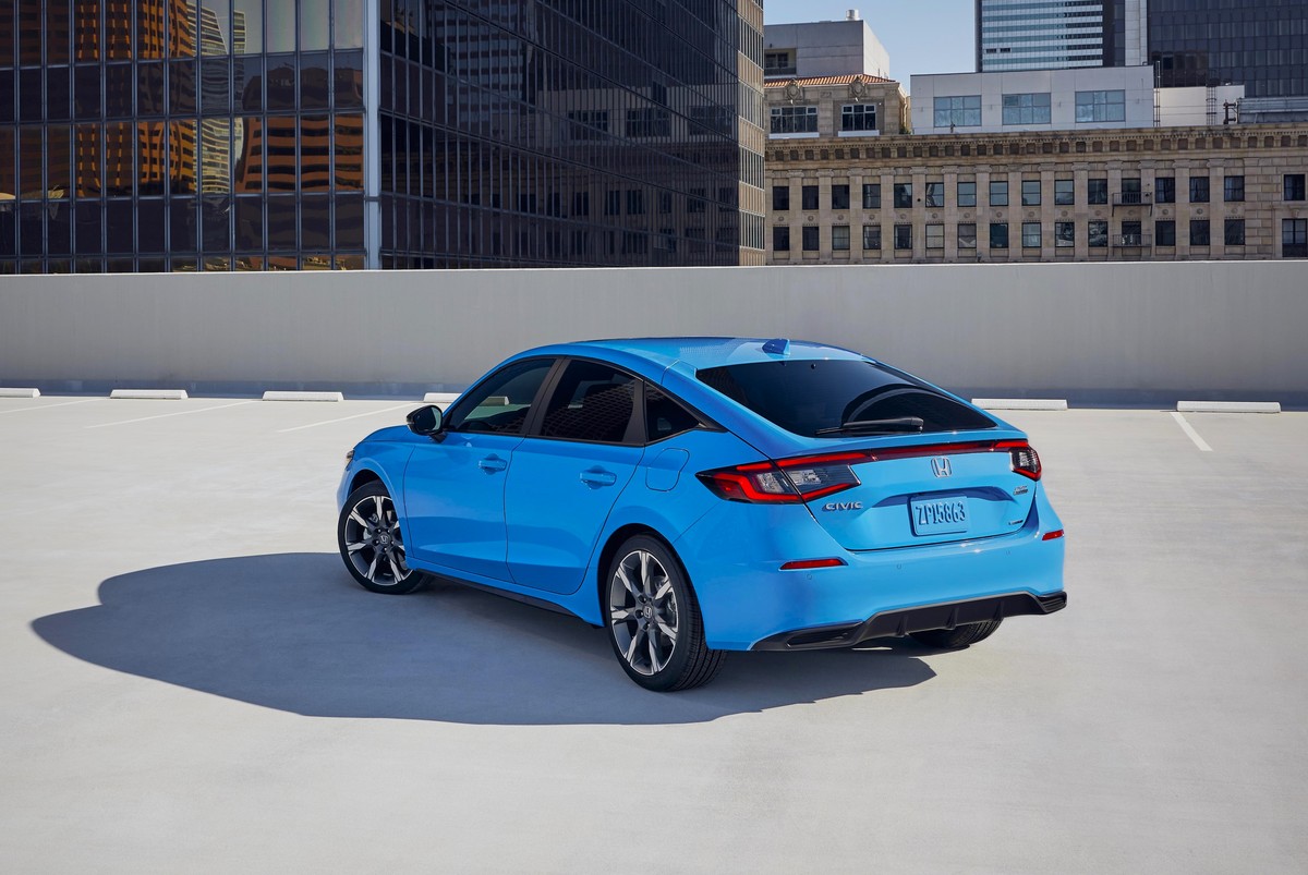 The 2025 Honda Civic Hybrid hatchback seen from a rear quarter angle