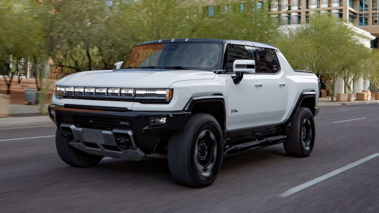 2024 GMC HUMMER EV Edition 1 Pickup driving on a city road.