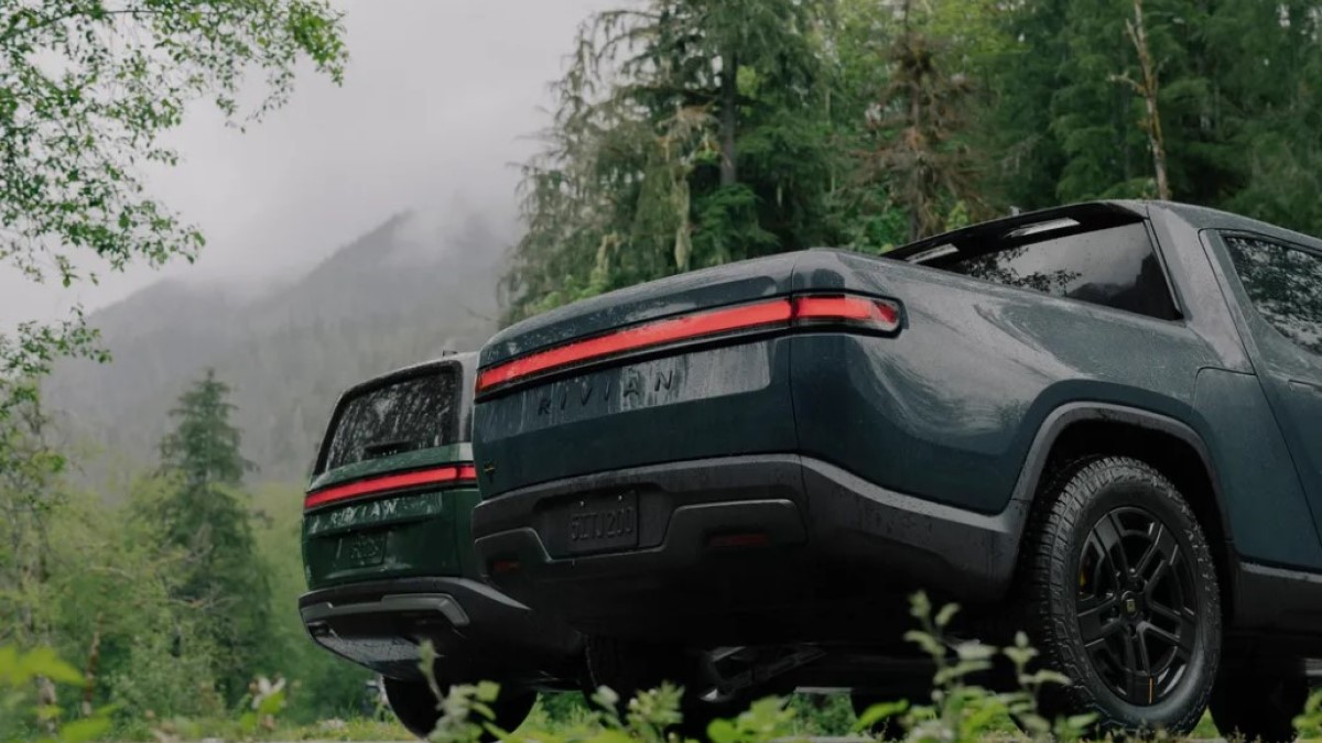 The 2025 Rivian R1T and R1S seen from a rear quarter angle