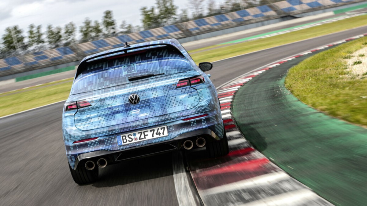 A teaser photo showing the 2025 Volkswagen Golf R from the rear, wrapped in camouflage