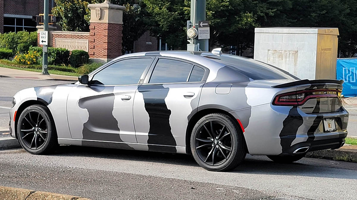 Dodge Charger with a gray and black camo pattern wap.